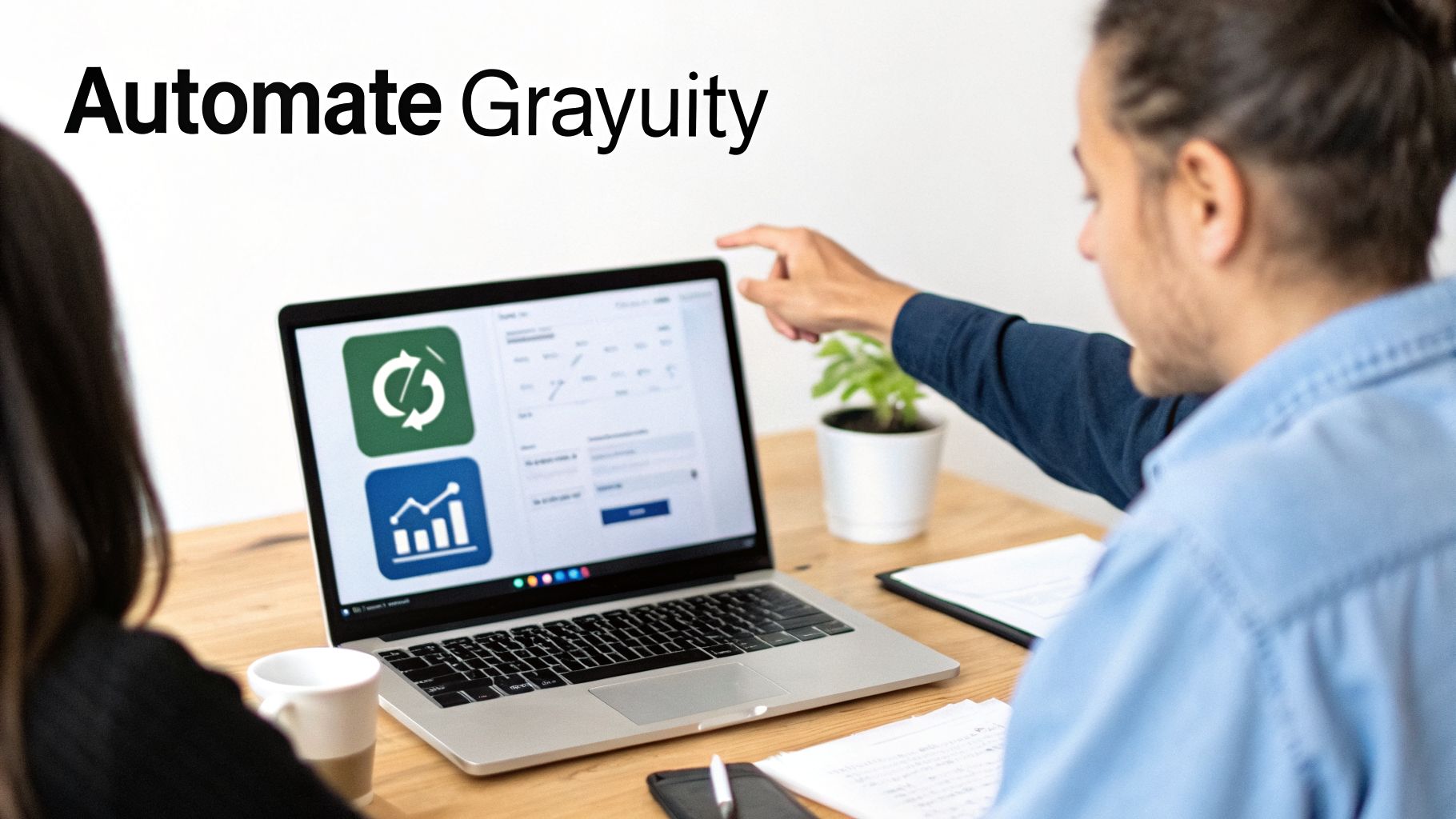 How to Calculate End of Service in UAE: A Guide for Businesses 4 Two colleagues looking at a laptop with 'Automate Grayuity' text, one pointing at the screen.