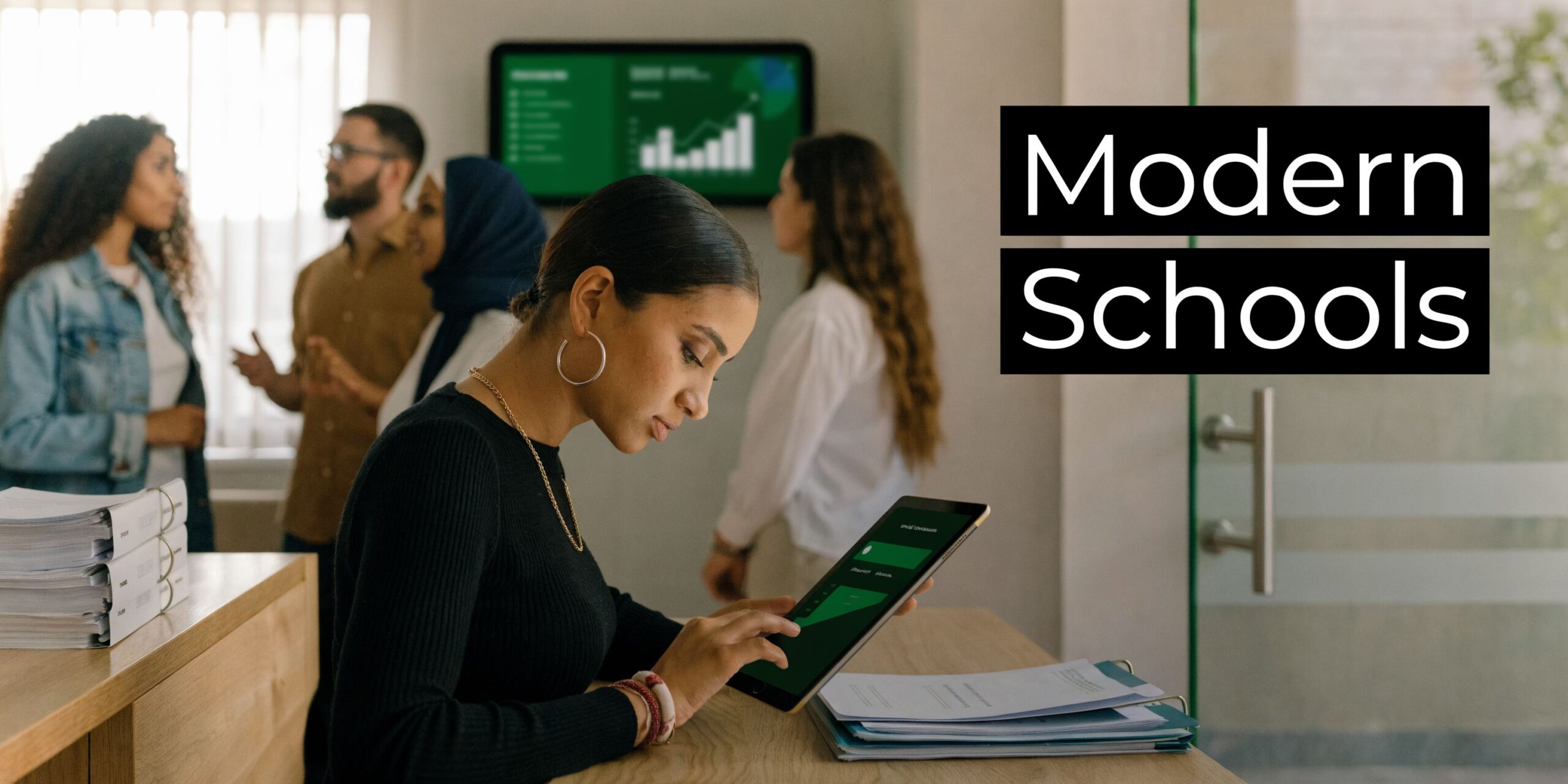 The Ultimate Guide to School Management Software in the UAE for 2026 1 A professional woman uses a digital tablet while a diverse team collaborates in a modern office environment.